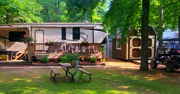 Seasonal campground park RV and trailer camp sites at Pineland Camping Park in Big Flats WI