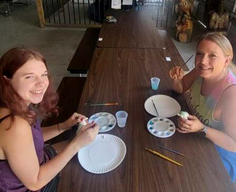 Campers at Pineland Camping Park participate in themed ceramics craft painting
